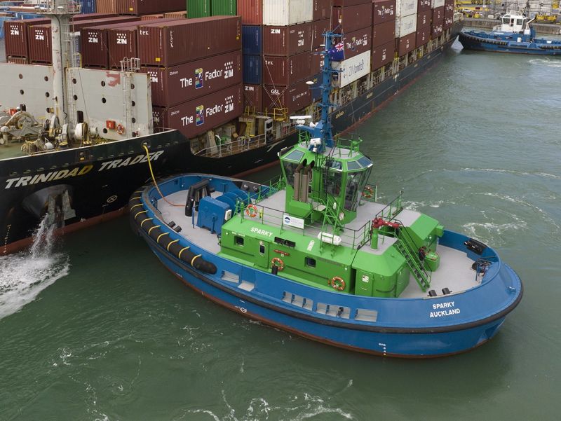 Ein blau gestrichener Hafenschlepper mit der Aufschrift "Sparky" im Einsatz im Hafen von Auckland. Bild: Damen